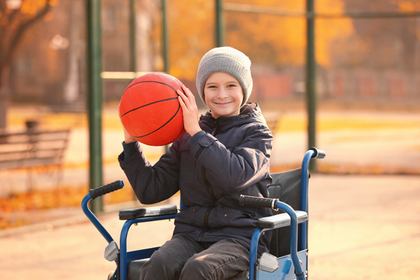 Child in wheelchair with basketball